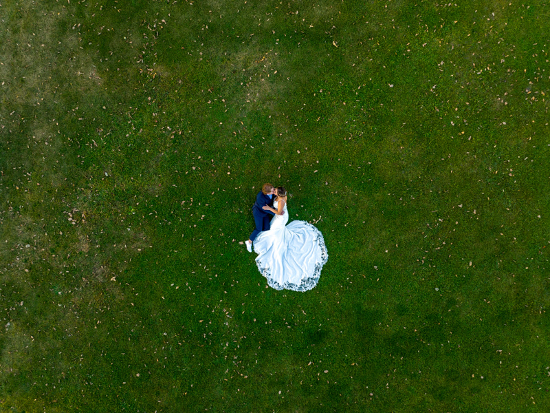 Bride and groom sharing a golden hour moment under dramatic skies